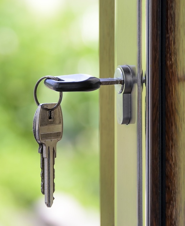 Key opening the door of a Tucson rental property